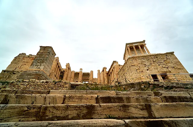 The monumental steps climbing to the Propylaea, seen from below under a pale sky